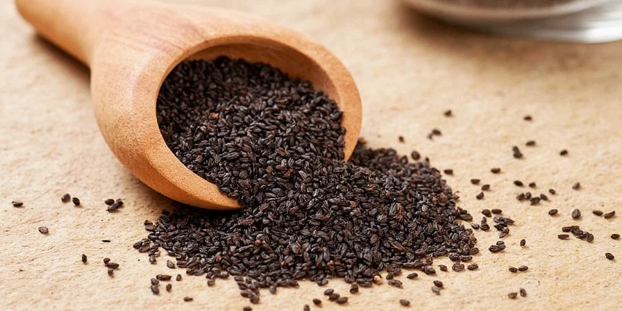 Close-up photo of organic black cumin seeds in a wooden spoon
