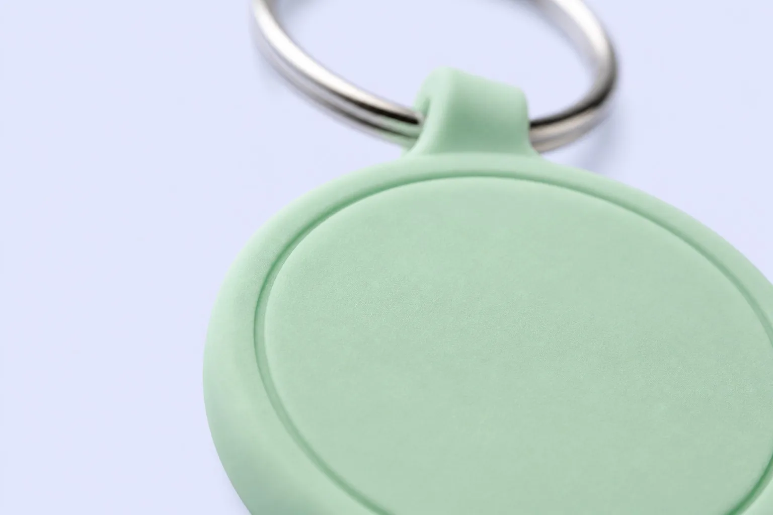 Mint green PVC epoxy keychain tag with silver split ring, close-up