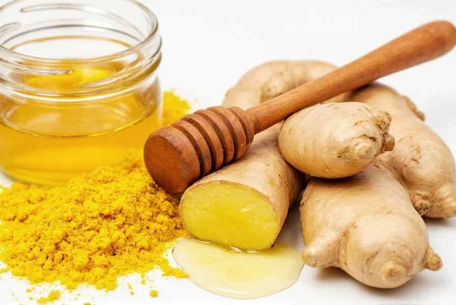 Raw honey, turmeric root, and fresh ginger on wooden cutting board