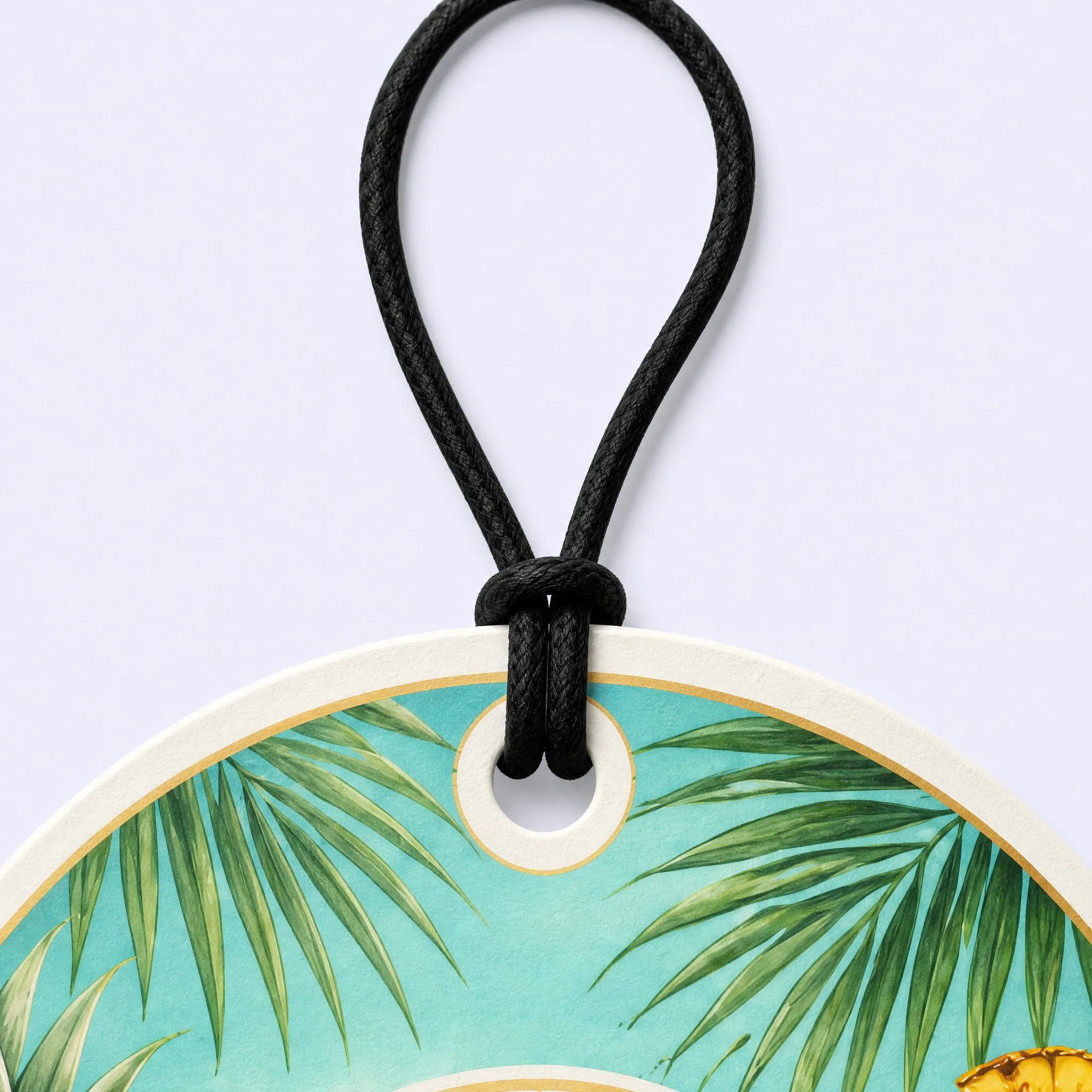 Top Detail of Piña Colada Air Freshener with Elastic Cord Loop and Tropical Palm Leaves