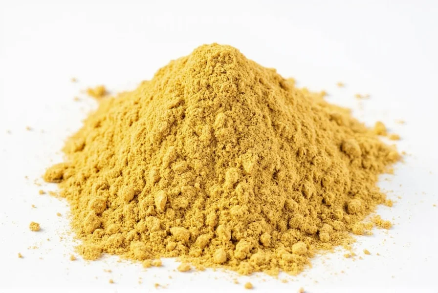 Fresh ginger root next to ground ginger powder in measuring spoons