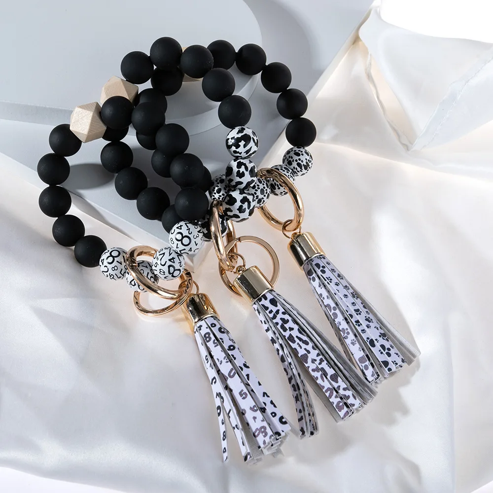 

Black Wooden Beaded Dog Paw Cow Print Bracelet Tassel Beaded Keychain