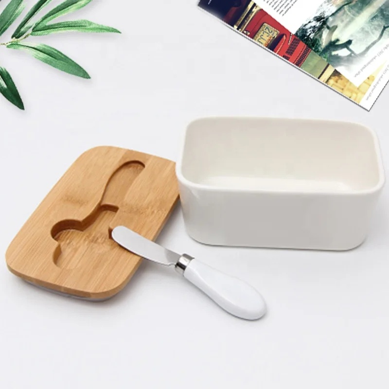 

Hot selling 2021 Ceramic Nordic Style Butter Box Butter Keeper Container Food Storage Candy Box Baking Dish with Wood Lid Knife, White color