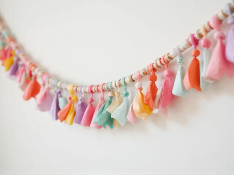 Colorful paper bead garland hanging on wall
