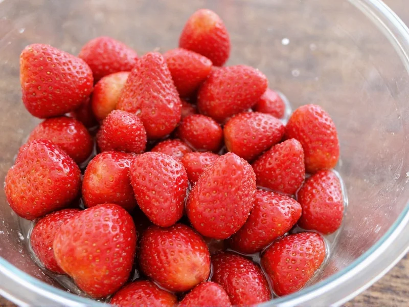 Vinegar solution washing fresh strawberries in glass bowl