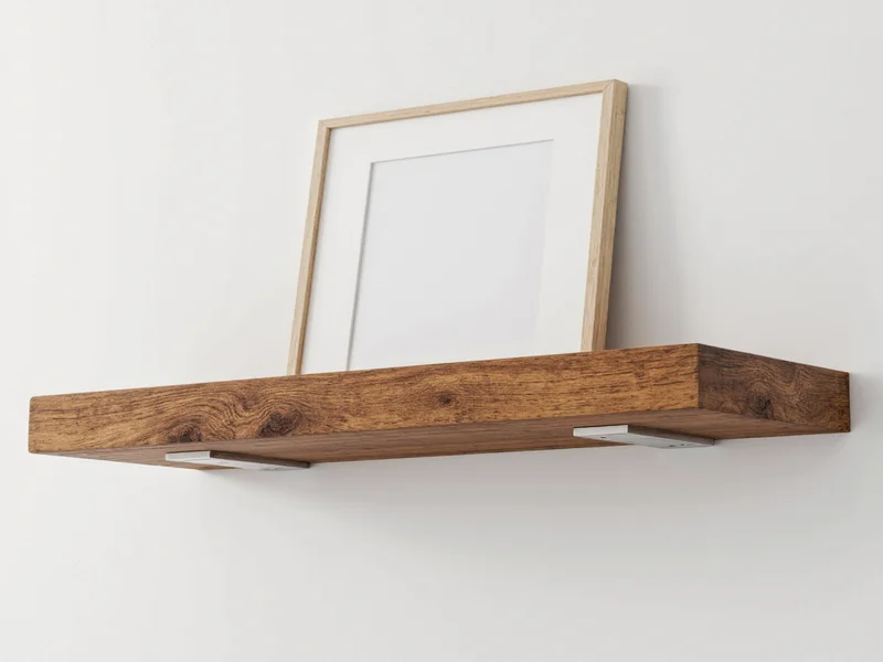 Reclaimed wood floating shelf installation with hidden brackets