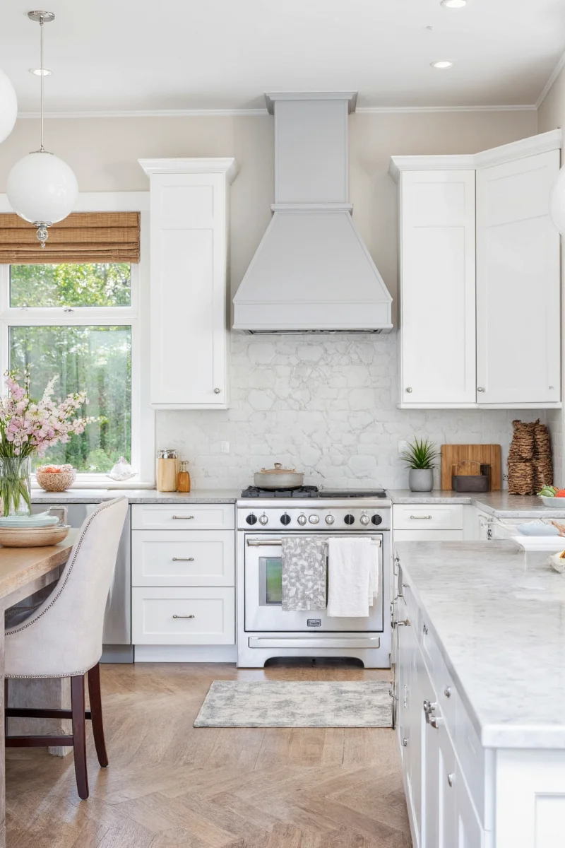 Gray and white kitchen with colorful bar stools and wooden decor