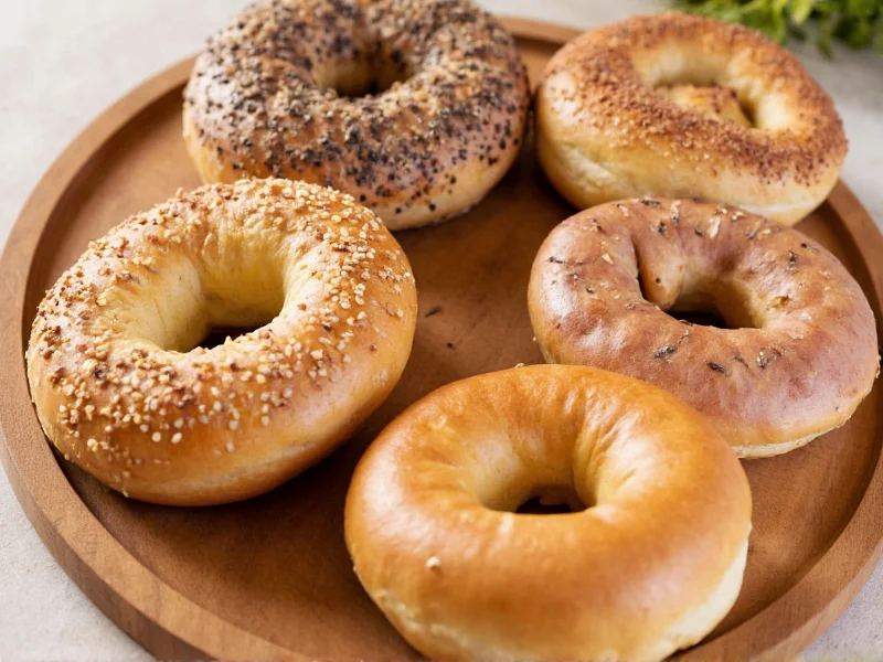 Assorted homemade bagel varieties on wooden board