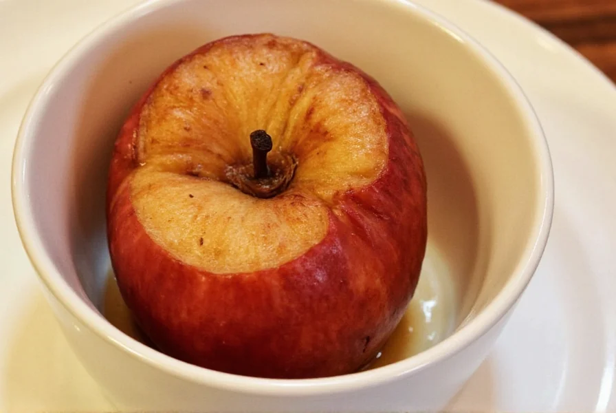 Finished baked cinnamon apples with golden brown topping served in white bowl