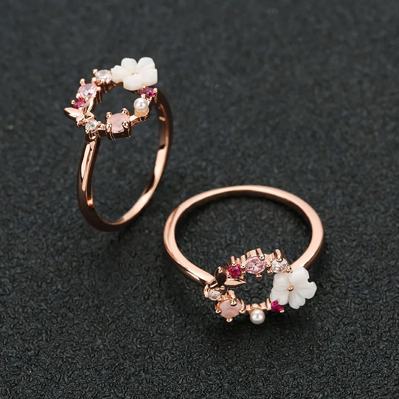 

KOMI Copper Alloy Rose Gold Plated Crystal Pearl Hollow Round Butterfly Flower Ring Jewelry Women