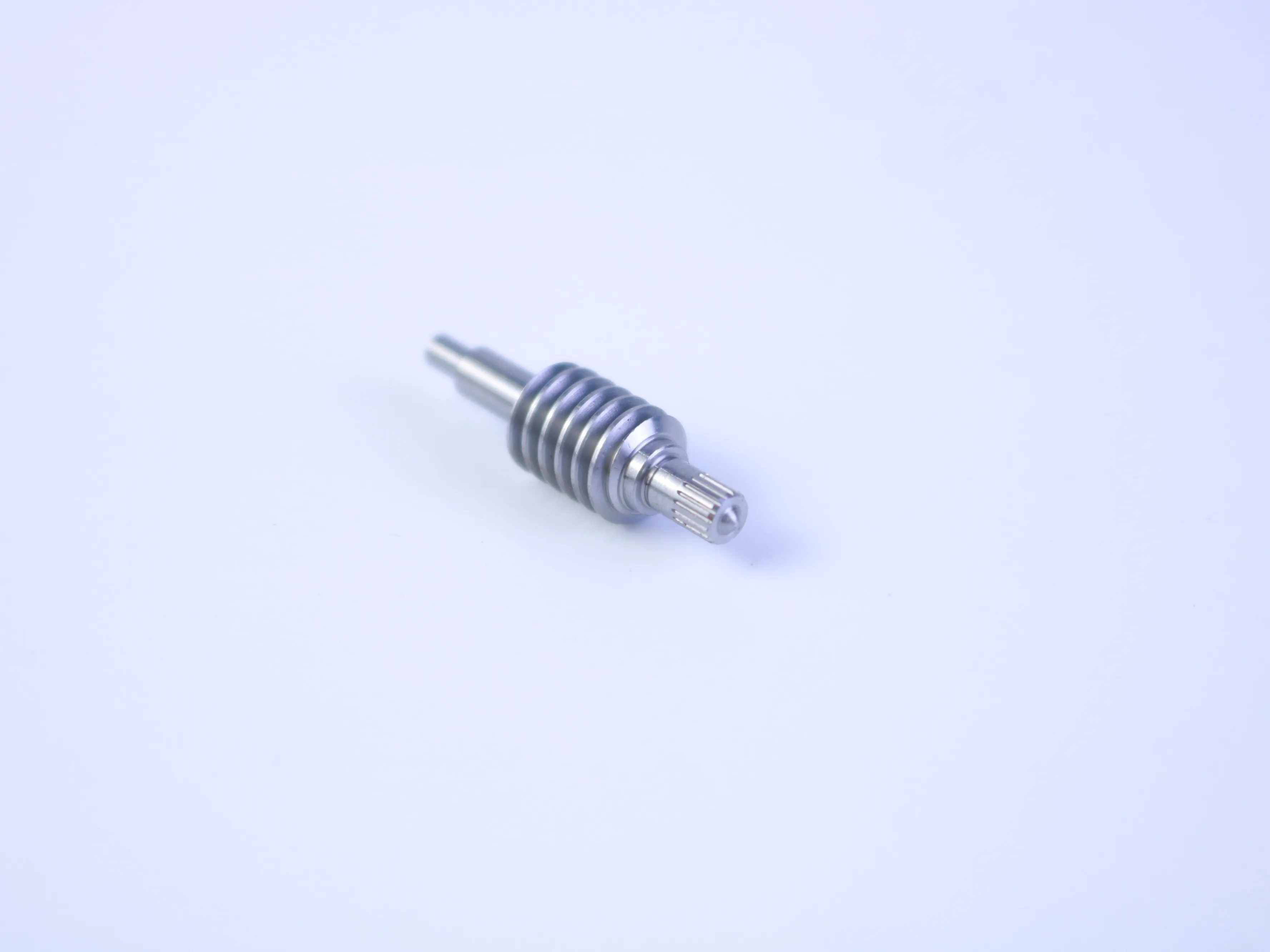 CNC machined worm-shaft-like component with helical teeth and a splined end
