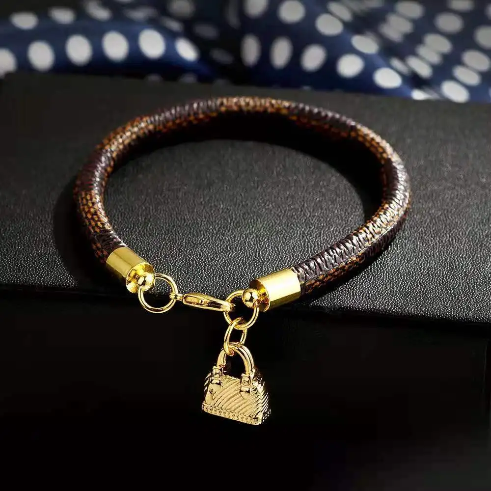 

Hot Selling Fashion New PU Striped Leather Copper Plated Gold Round Lock Bag Bracelet