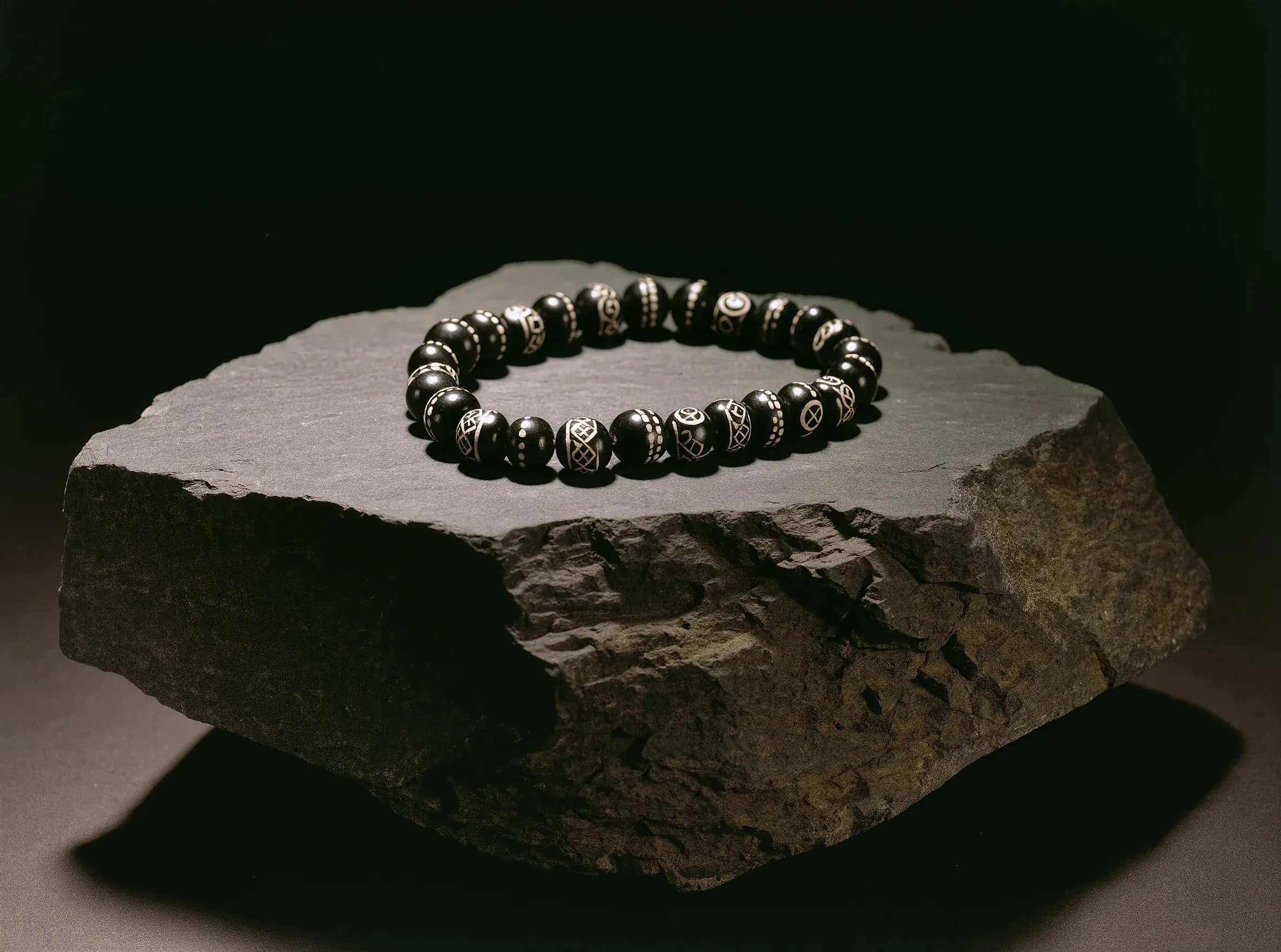 Terms of Service 1 Sovereign Stillness Jewelry Terms: A handcrafted obsidian relic on a solid stone bedrock, representing our unyielding legal framework.