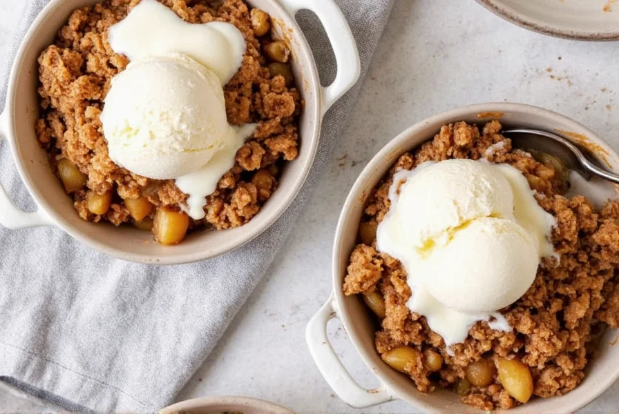 Two serving dishes of cinnamon apple crisp with vanilla ice cream melting on top