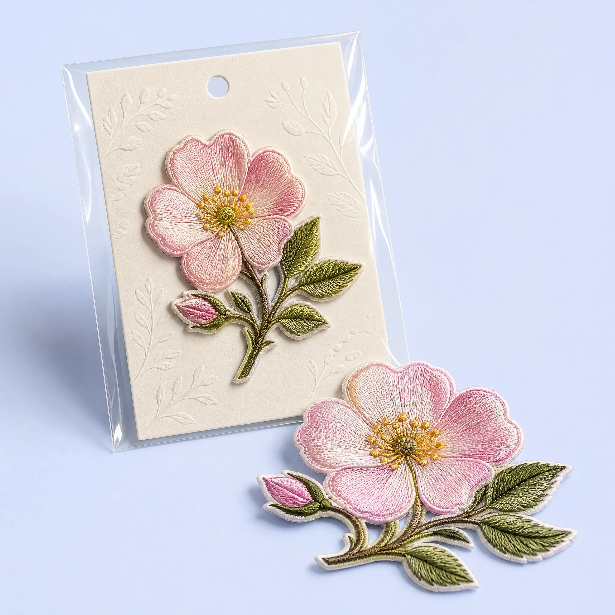 Boutique Botanical Art Packaging: Wild Rose Patch Mounted on Embossed Foliage Cardstock Backing inside Clear Hanging Poly Pouch
