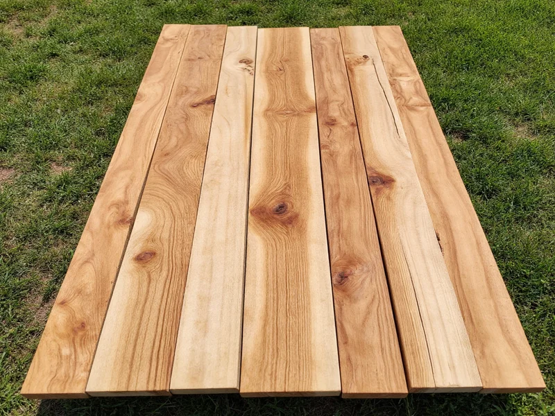 Reclaimed wood pieces laid out for umbrella stand project