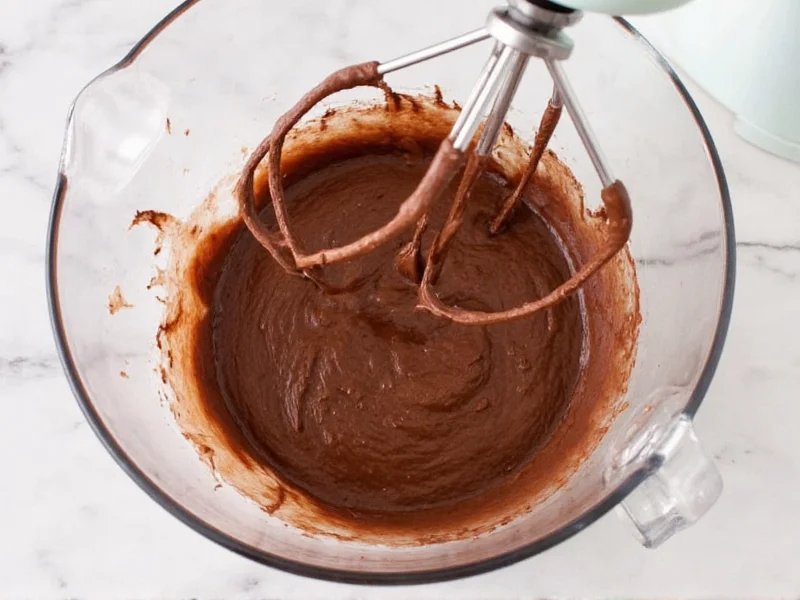 Whipping chocolate frosting in stand mixer bowl