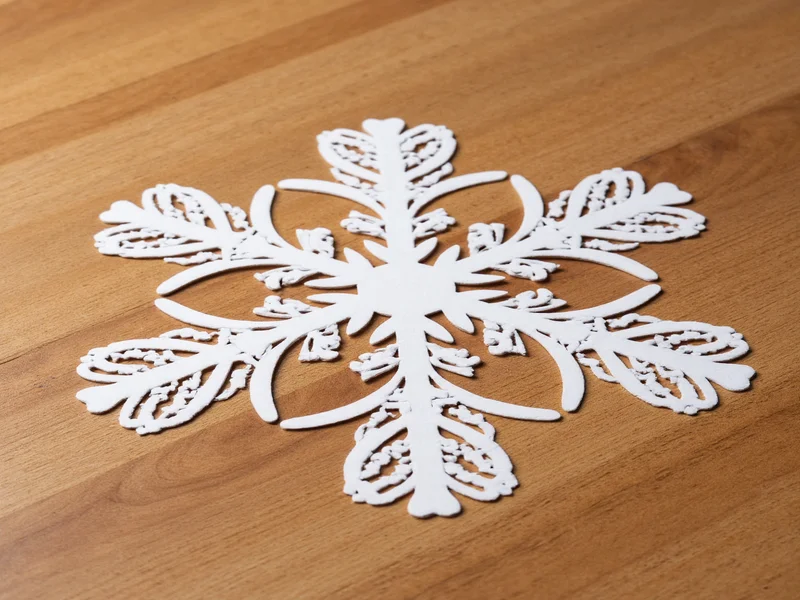 Paper snowflake materials on wooden table