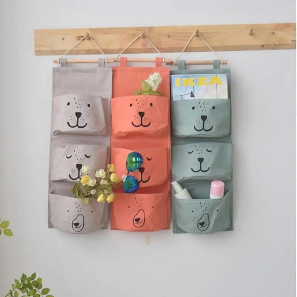 

Simple cotton and linen cartoon three-pocket storage hanging bag for home decor