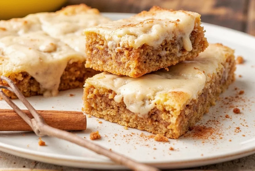 Homemade cinnamon rolls with cream cheese frosting on a rustic wooden table