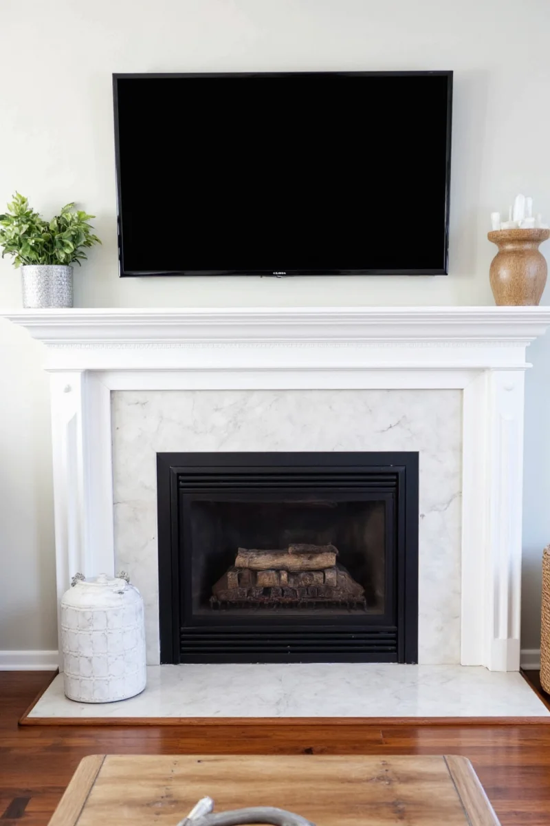 Modern living room with TV above fireplace mantel
