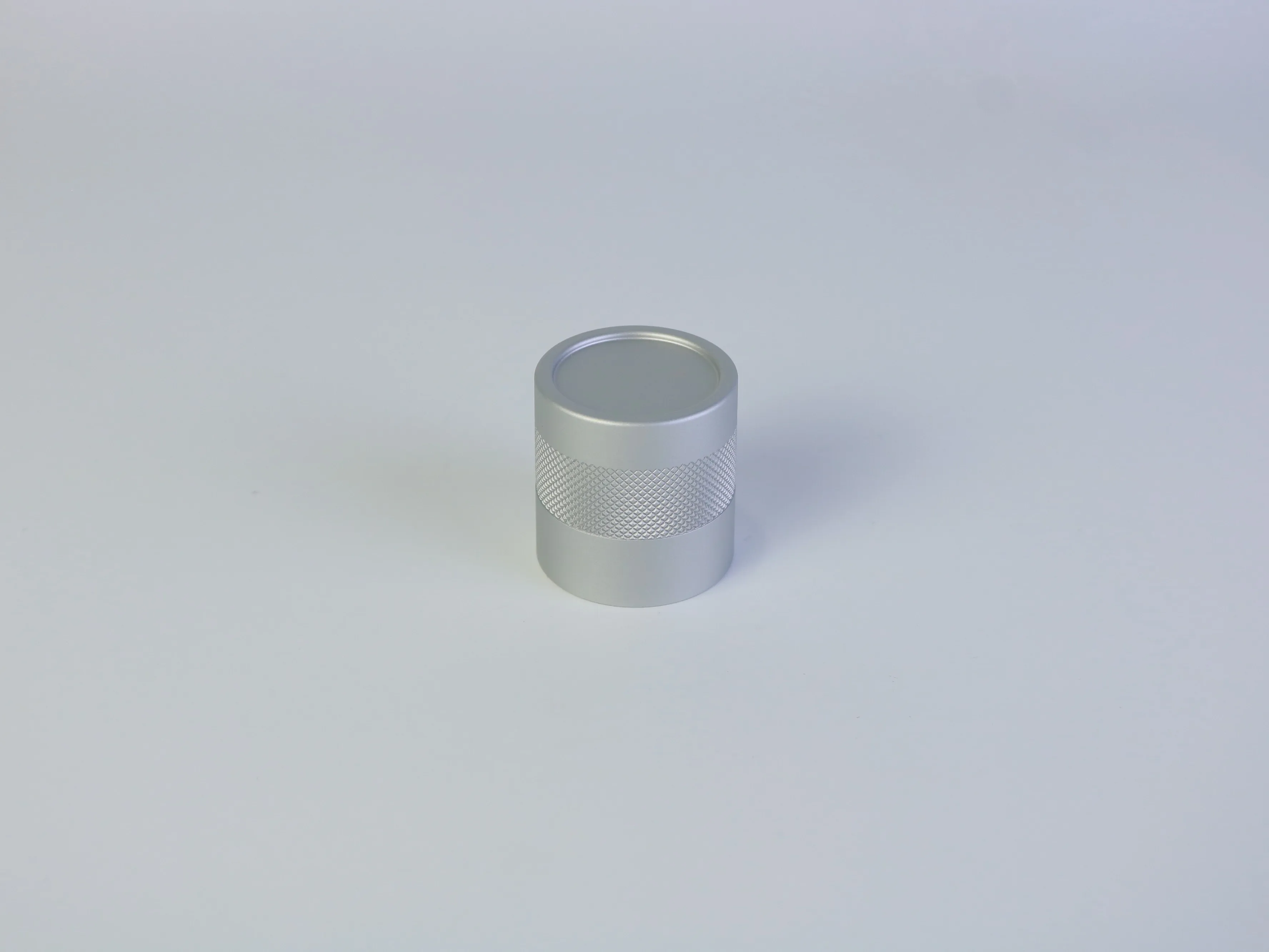 Custom CNC turned aluminum cylindrical housing with diamond knurled band