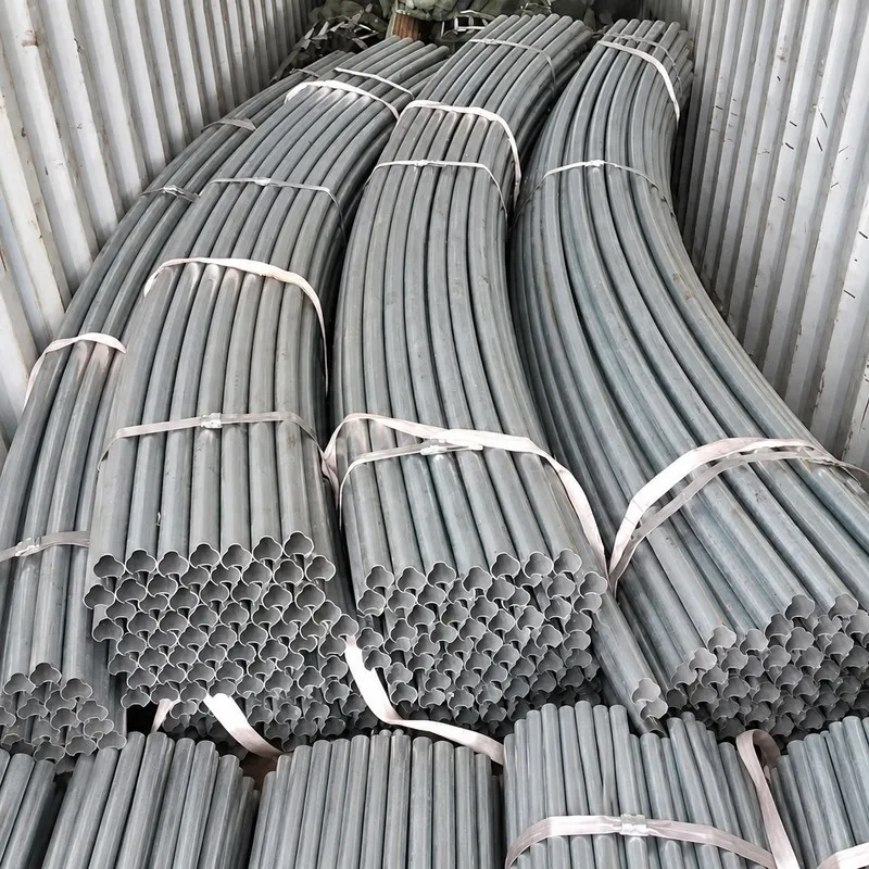 Bundled greenhouse arch pipes arranged inside a shipping container.