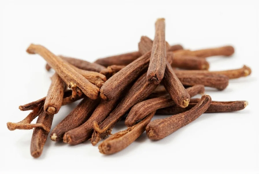 Close-up of whole cloves and ground cloves showing texture differences
