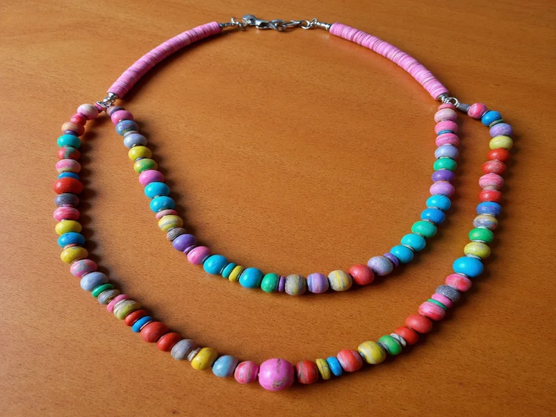 Colorful paper bead necklace on wooden display