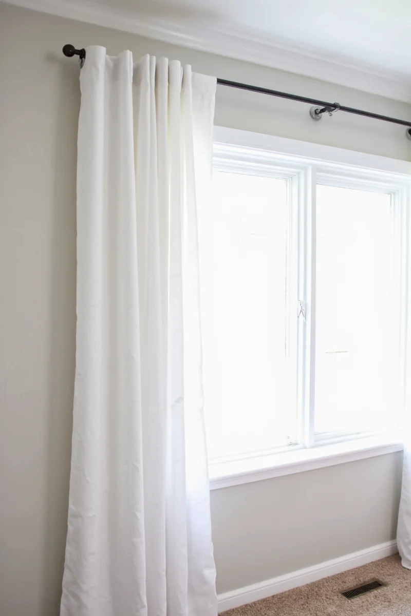 Tension rod installed with curtains