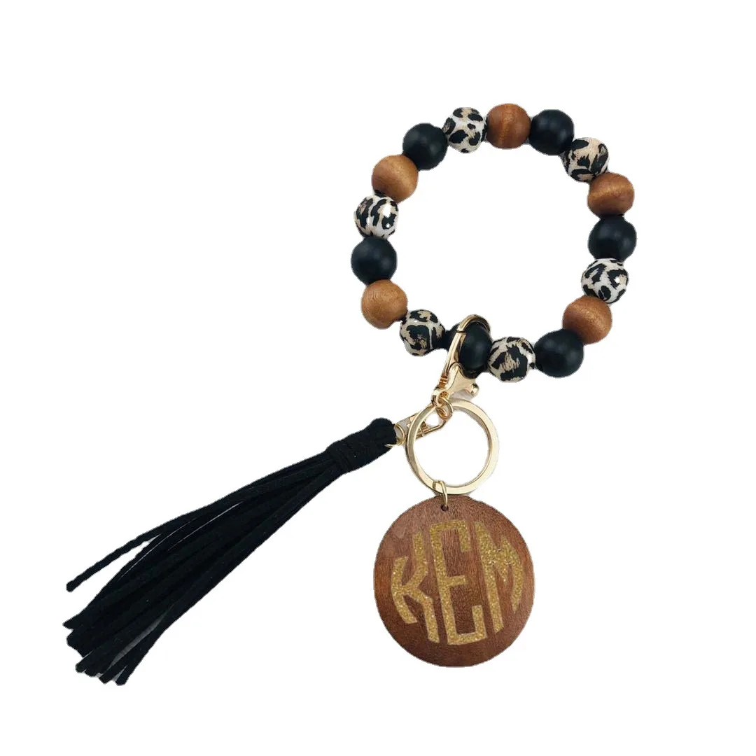 

Wholesale Newest Silicone and Wood Beads Key Chain Bracelet for Women Large Circle Keyring Bracelet Stocks PU Tassel Bracelet
