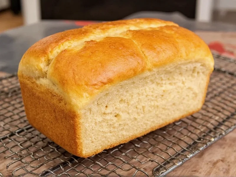 Golden brown homemade bread loaf cooling on rack
