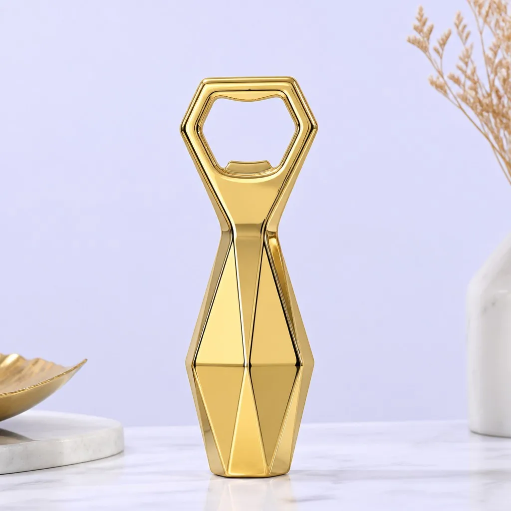 Faceted gold bottle opener displayed on a white marble surface with minimal home decor