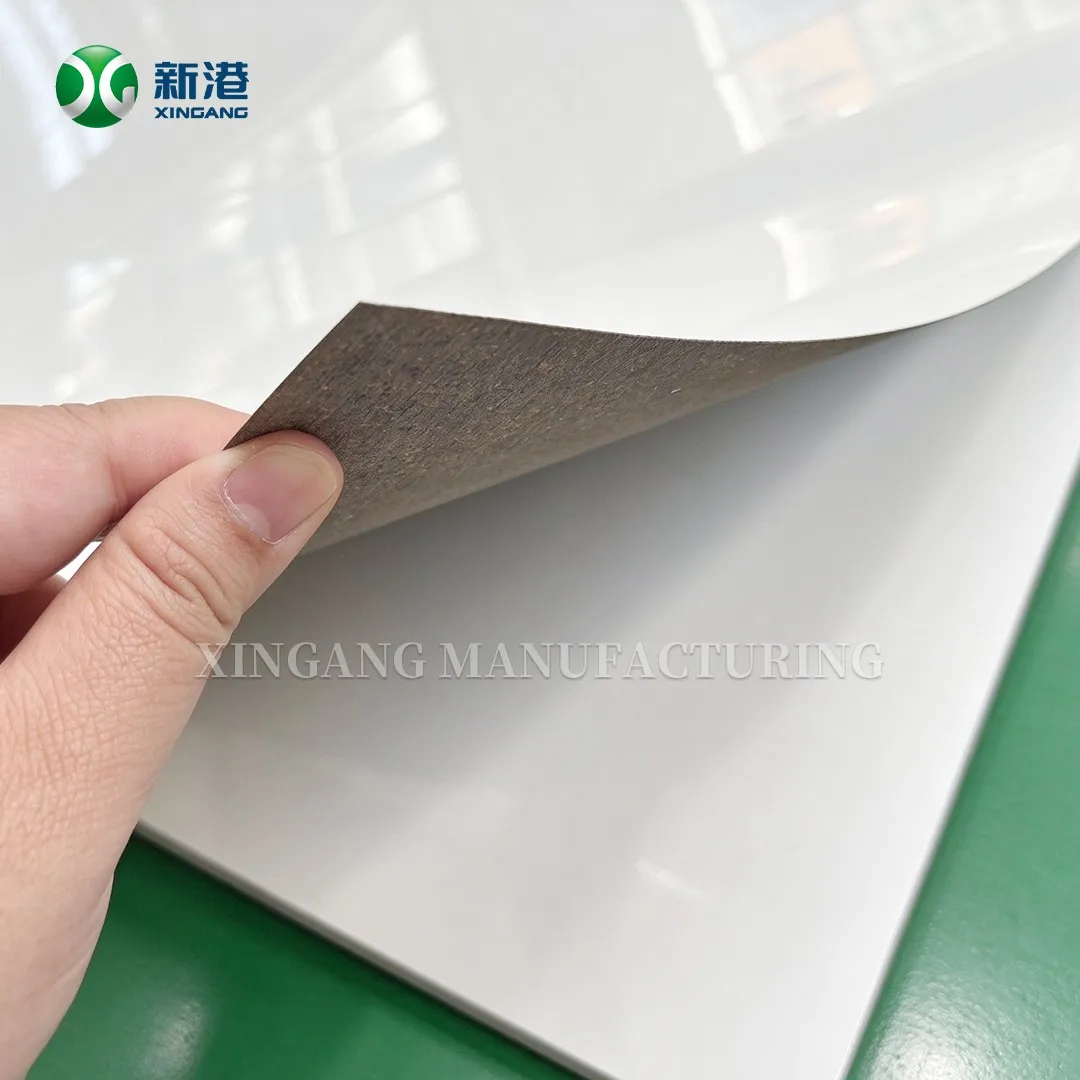 Corner of a white gloss HPL sheet lifted to show the sanded backing