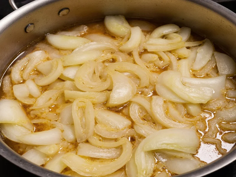 Onion caramelization stages in french onion soup preparation