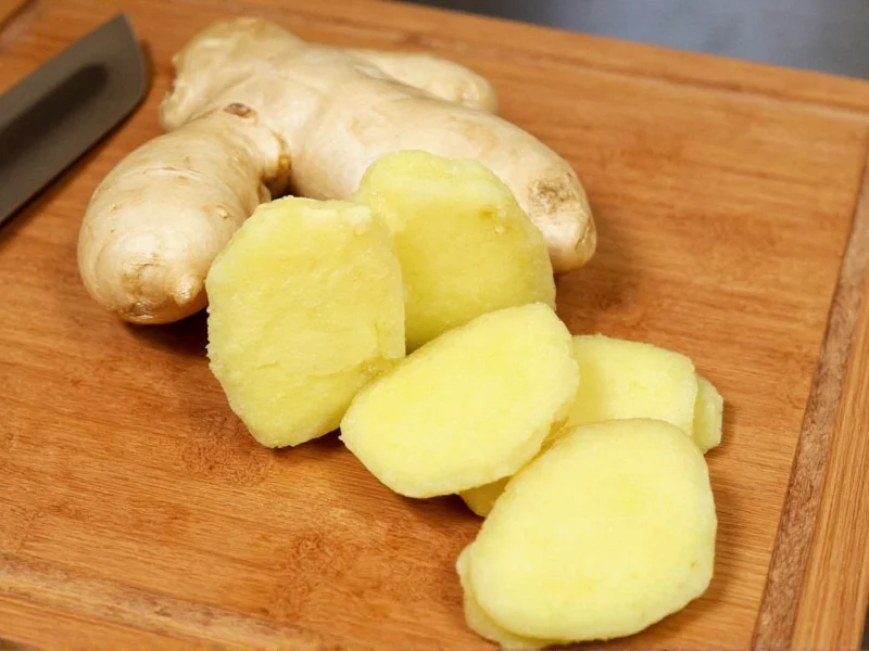 Organic ginger root pieces on wooden cutting board