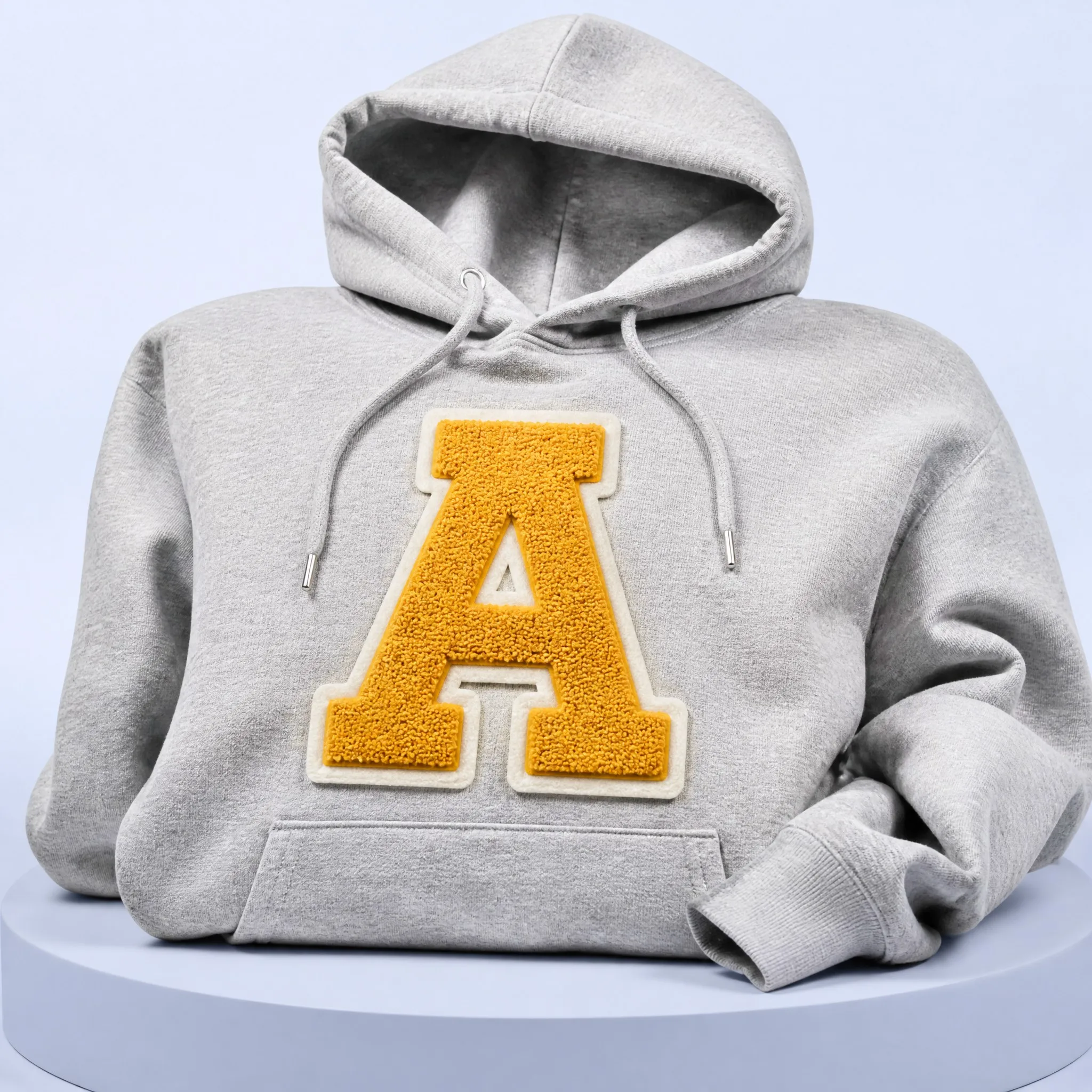 Oversized Heather Grey Streetwear Pullover Hoodie with Large Gold Chenille Varsity Letter A Patch Mounted on Center Chest