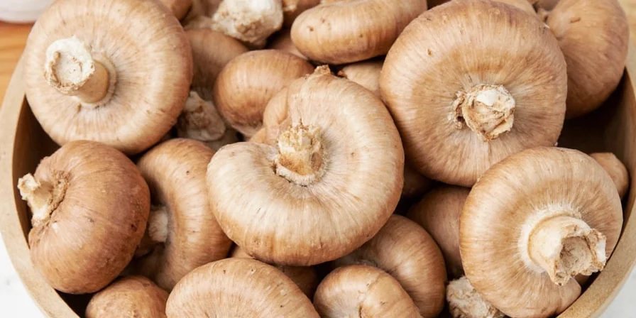 Fresh white mushrooms on a wooden board