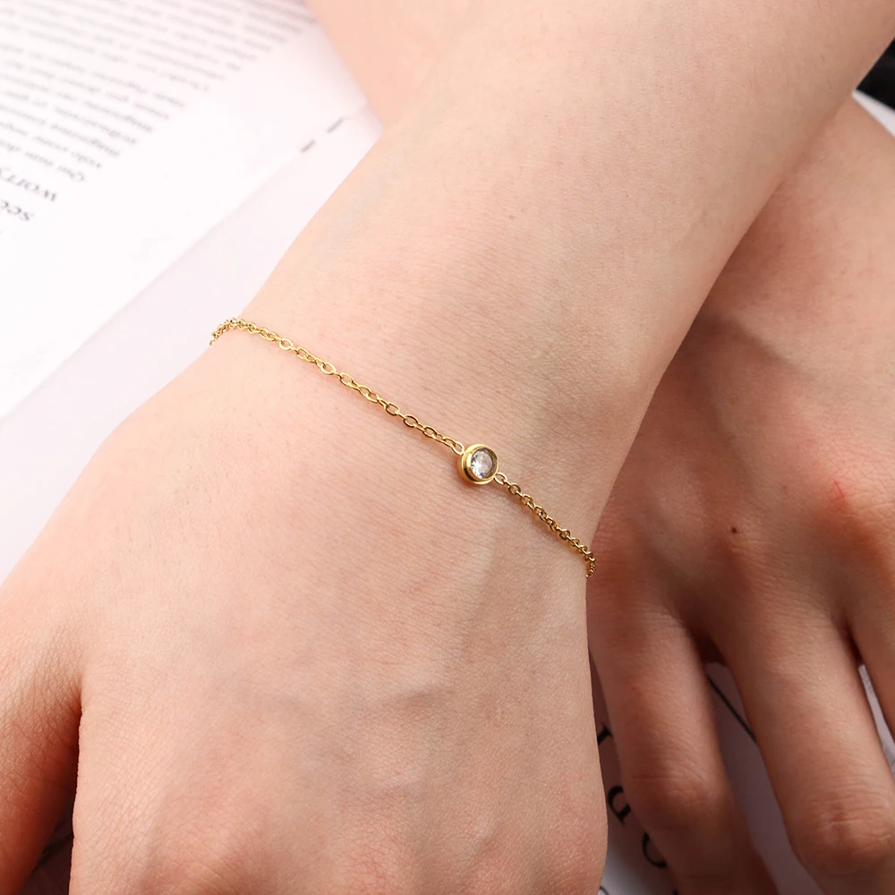 

Chris April 316L stainless steel gold plated simple solitaire bracelet zircon charm
