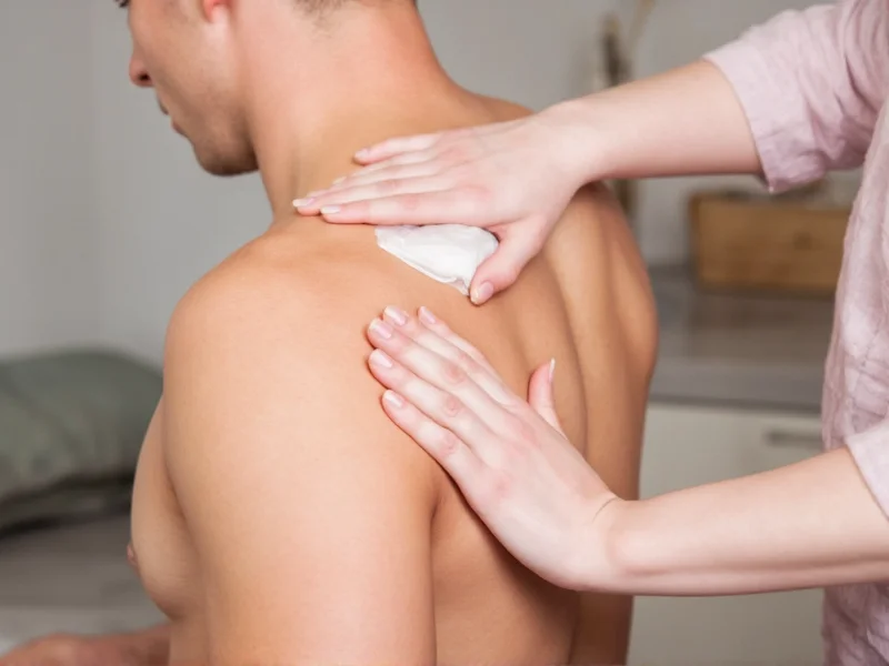 Applying homemade ice gel pack to shoulder injury