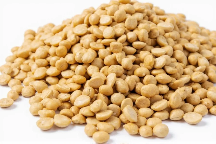 Close-up of fenugreek seeds showing their small, amber-colored oval shape on a wooden spoon