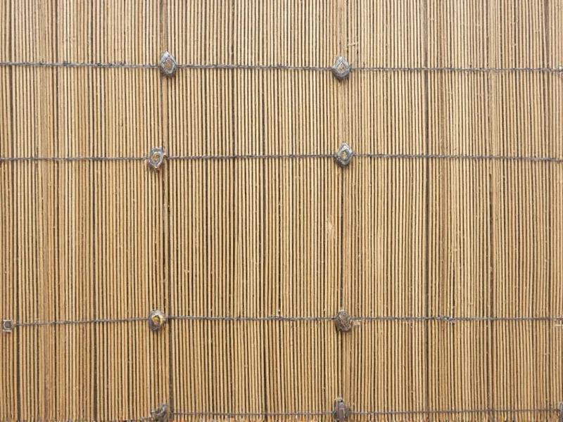 DIY fence with post caps and tension wires for bamboo panels