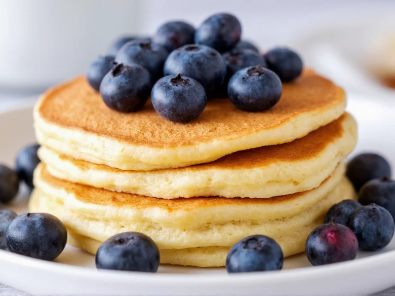 Stack of fluffy pancakes with blueberries