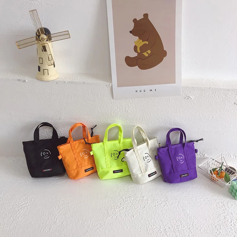 

2022 children's bag new Korean casual printed smiling face canvas bag handsome boy messenger bag fashion coin purse