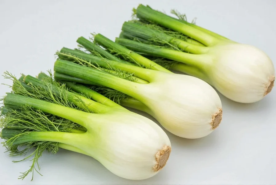 Roasted fennel bulbs with herbs on a baking sheet