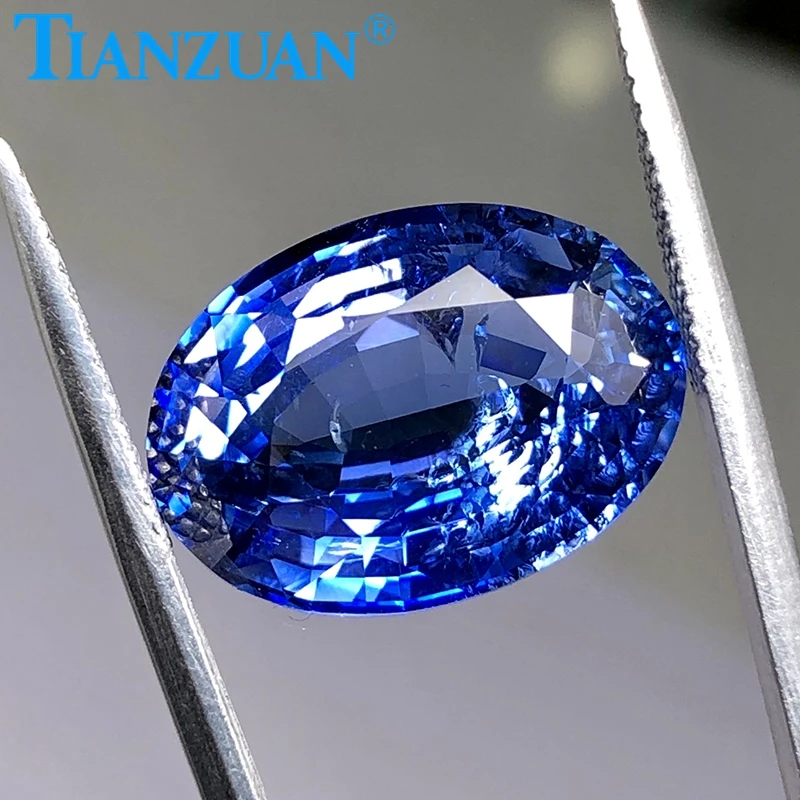

Cornflower blue synthetic Sapphire Thailand cutoval shape corundum gem stone with cracks and inclusions