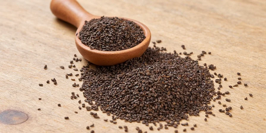 Mug of tea with black cumin seeds floating in it