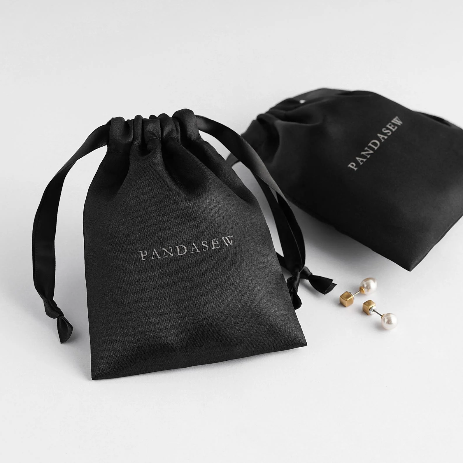 

PandaSew Wholesale Luxury Black Drawstring Satin Jewelry Pouch Dust Bag with Custom Logo Printed, Accept customized color