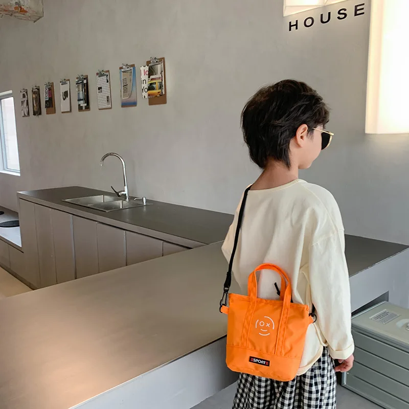 

Korean canvas children's boys and girls kindergarten baby slung accessories English letter cloth bag for men and women