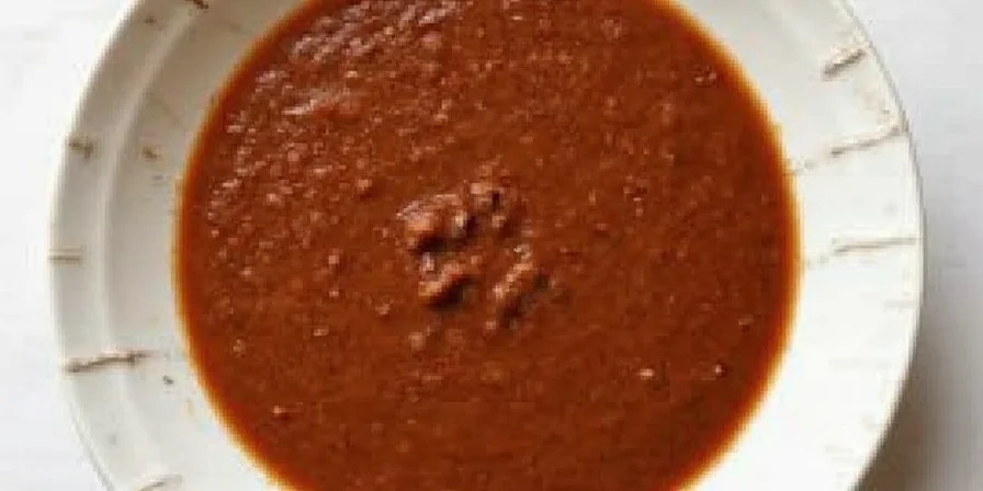 Mole Sauce Being Served Over Chicken